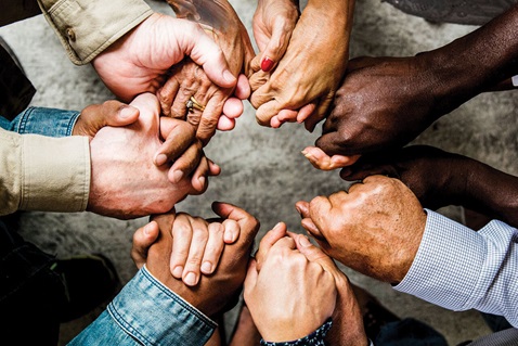 A diverse group of people stand in a circle holding hands. Image by Rawpixel, iStockphoto.com.  A diverse group of people stand in a circle holding hands. Image by Rawpixel, iStockphoto.com.