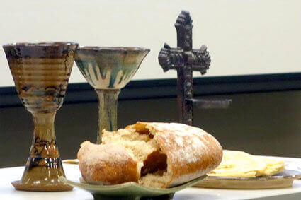 Communion table with chalices, broken bread, and a cross. Image courtesy Connectional Table. Communion table with chalices, broken bread, and a cross. Image courtesy Connectional Table.