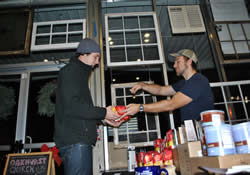 Levi Rogers (right) sells Mason Reedy some of the fairly traded coffee used at Oakhurst United Methodist Church in Decatur, Ga. The church uses as many fairly traded products as possible.