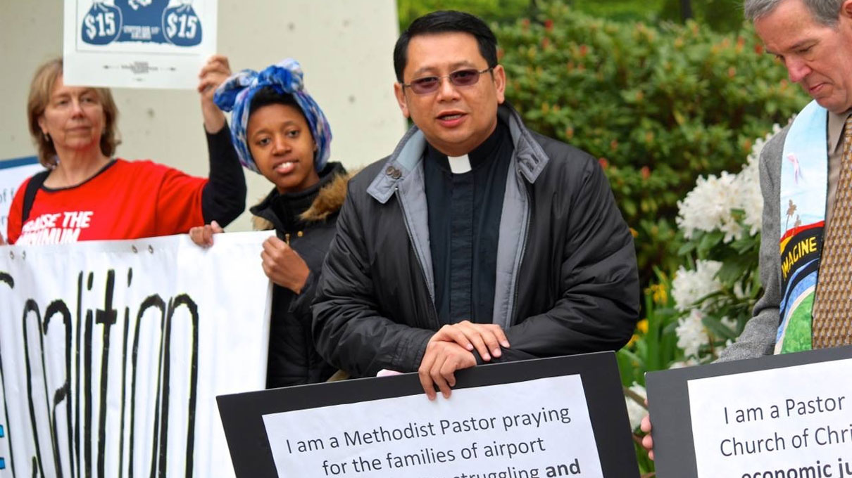 The Rev. Mark Galang (second from right) joins a demonstration advocating a living wage for workers at the Seattle-Tacoma International Airport. Courtesy photo.