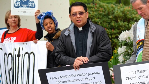 2519_4787_markgalang The Rev. Mark Galang (second from right) joins a demonstration advocating a living wage for workers at the Seattle-Tacoma International Airport. Courtesy photo.