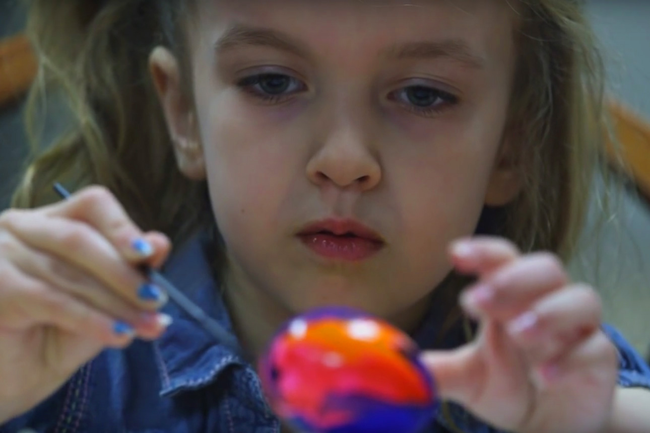 Cadence paints an egg for Easter.  