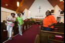 2110_4050_newsanctuaryandhymnals Church members (from left) Burnetta D. Fauria, Angelique White-Williams and Andrea Sanchez-Reese show the restored sanctuary at Hartzell United Methodist Church in New Orleans' Lower 9th Ward. Among the items dedicated last year were new imprinted hymnals from Cokesbury Cares. Photo by Mike DuBose, UMNS.