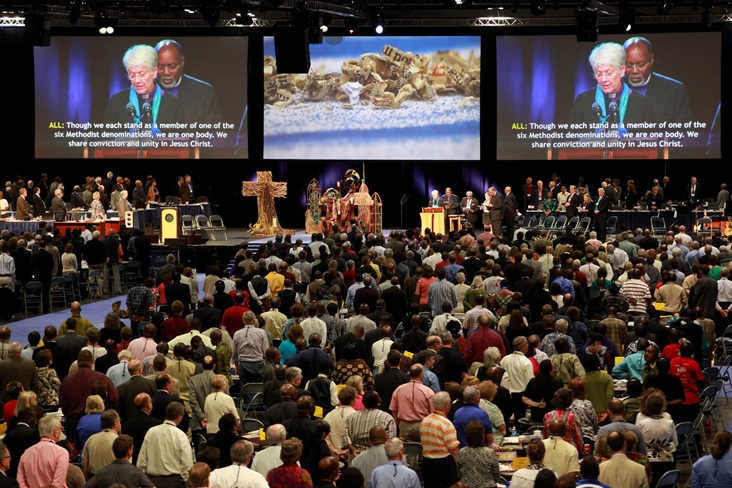 gc2012-pan-methodist-communion-celebration Delegates and visitors fill the plenary hall in the May 1 afternoon celebration of Pan-Methodist Full Communion at the 2012 United Methodist General Conference in Tampa, Fla.  On the screen are Bishop Sharon Rader and Bishop John White.