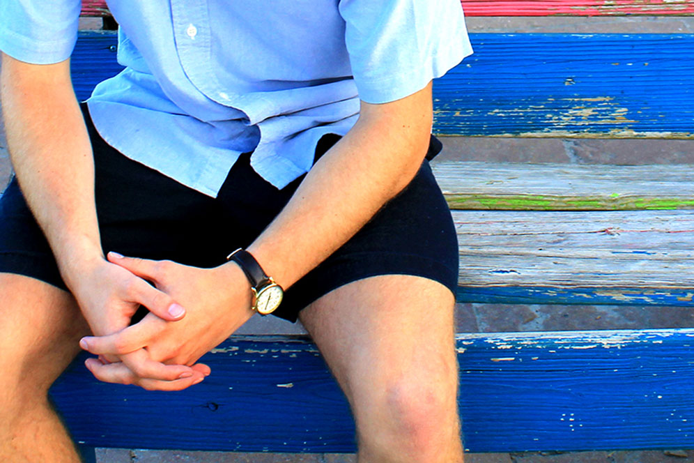 Man sits on bench, hands folded. Photo illustration by Kathryn Price, United Methodist Communications.