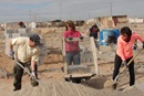 juarez-mission-trip-sifting Mission team members from Suncreek United Methodist Church sift out rocks as part of the mortar-making process. They spent three days building a cinder-block home for the Quinoñes family of Ciudad Juárez, Mexico. Photo by Sam Hodges, UMNS