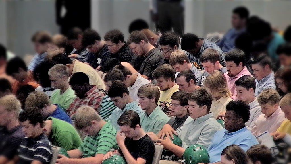 Football players gather at Christ United Methodist Church, Chattanooga, Tennessee, for "Blessing of the Helmets Sunday."