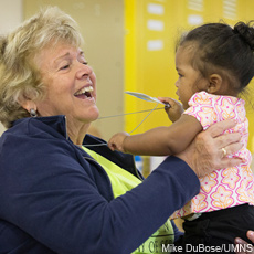A volunteer plays with a young girl at the St. Benedict Center for Early Childhood Education in Louisville, Ky.