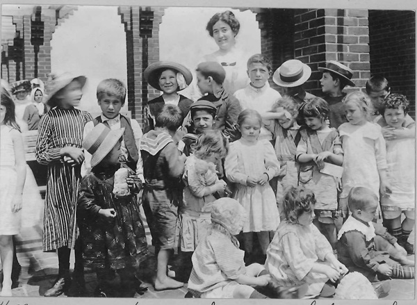 Matron Fitzgerald poses with children of Morgan Memorial Church. Located in the South End district of Boston, Morgan Memorial was also known as the Church of All Nations because of the various ethnic groups and religions that it reached through its mission program. One of its most famous missions was an  industrial cooperative called Goodwill Industries, incorporated in 1905. Image courtesy of Archives and History.