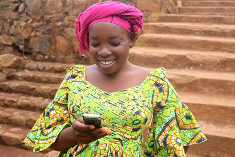 Gracia Wakusomba, a pregnant mother of three, reads a text reminding her of an upcoming appointment at the United Methodist Health Center in Irambo, Democratic Republic of Congo. The hospital works in partnership with central conference communicators to relay the messages. Photo by Philippe Kituka Lolonga, UMNS.