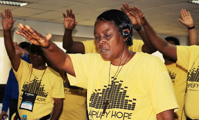 Gefanie Buntu Ngoie from the Democratic Republic of Congo prays during the United Methodist Radio Network meeting in Luanda, Angola. Photo by Taurai Emmanuel Maforo, UMNS.