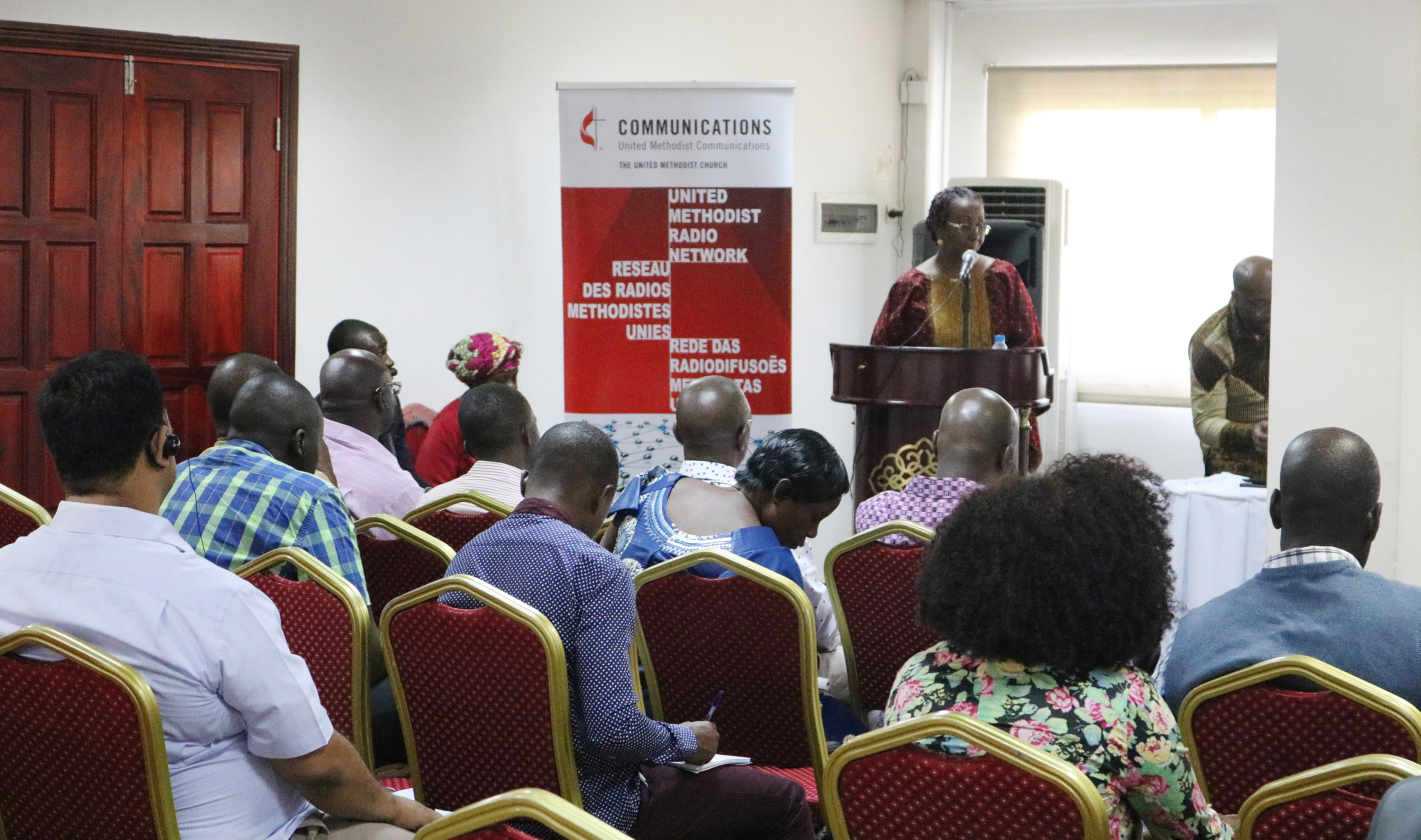 Madame Lydie Acquah, station director at the Voice of Hope (101.6 FM) radio in Côte d’Ivoire addresses the United Methodist Radio Network participants. Acquah is the outgoing United Methodist Radio Network coordinator. Photo by Taurai Emmanuel Maforo, UMNS.