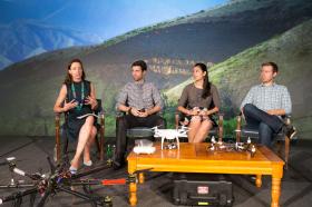 Unmanned aerial vehicles stand at the front of the stage during a discussion of how new technologies change lives at the 2015 United Methodist Communications Game Changers Summit in Nashville, Tennessee. From left are: Adele Waugaman, Thane Richard, Sara Pitcairn and Chris Tuckwood. Photo by Mike DuBose, UMNS.