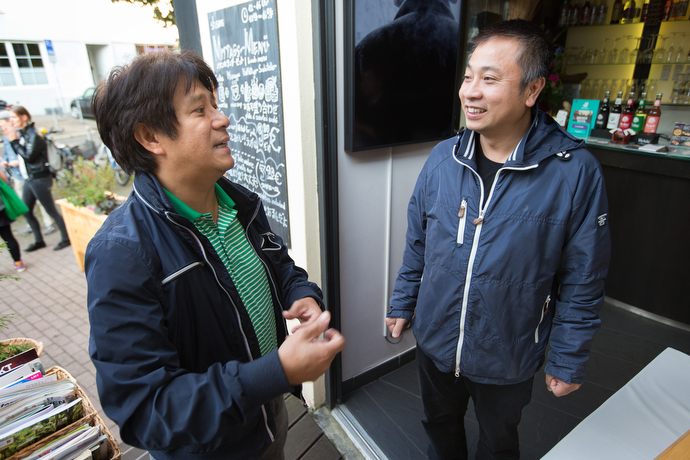 The Rev. Chi My Nguyen (left) visits with parishioner Nguyen Trung Dung at his sushi restaurant in Frankfurt, Germany. Nguyen is the only Vietnamese United Methodist pastor in Germany, serving a church of about 40 immigrants in Frankfurt. Photo by Mike DuBose, UMNS.