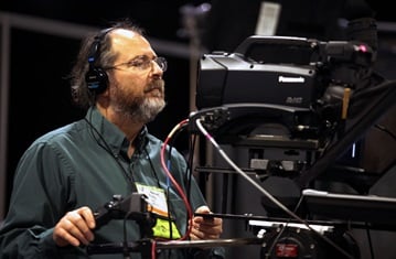 Videographer Ronny Perry records a press conference on April 25 during the 2012 United Methodist General Conference in Tampa, Fla. Perry is one of many United Methodist Communications' staff members working at General Conference. Photo by Kathleen Barry, UMNS.