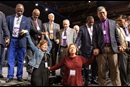 Florida delegates Rachael Sumner (front left) and the Rev. Jacqueline Leveron (front right) of the Florida Conference join in prayer with bishops and other delegates at the front of the stage before a key vote on church policies about homosexuality during the 2019 United Methodist General Conference in St. Louis. Photo by Mike DuBose, UMNS.