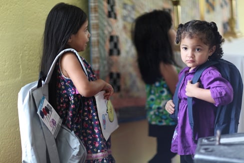 Cecilia Salamanca, left, and a young friend carry school backpacks. Photo by Kathleen Barry, UMNS