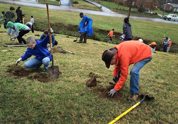 Cadence Cobb (left) and her mother, Megan Cobb, dig at Hillcrest United Methodist Church, Nashville, Tennessee. 75 volunteers from the congregation and the surrounding community planted 250 native trees as part of a Creation Care effort. Photo by Kathryn Spry