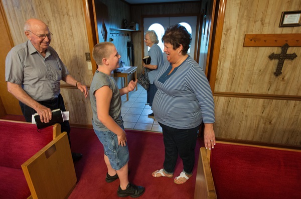 The Rev. Debbie Williams (right) visits with Everet Yates and his grandparents at Bethlehem United Methodist Church in Pilot Oak, Ky. Photo by Mike DuBose, UMNS
