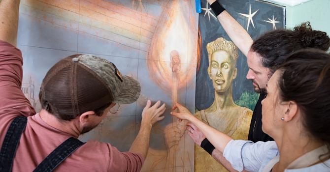 Artists Caleb Clark, Christopher Holt and Jill Hooper compare a tracing of preliminary drawings to the final composition of the fresco at Haywood Street Congregation. Holt is an artist trained in making frescoes; Clark and Hooper assisted him in the two-year-long project. Photos by John Warner/Warner Photography