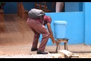 A visitor to United Methodist Mercy Hospital in Bo, Sierra Leone, washes his hands at a wash station before entering the hospital on March 16. Amid coronavirus concerns, the use of handwashing stations, previously used during the country’s fight against Ebola, has been stepped up in public places, including hospitals, banks and schools. Photo by Phileas Jusu, UM News.