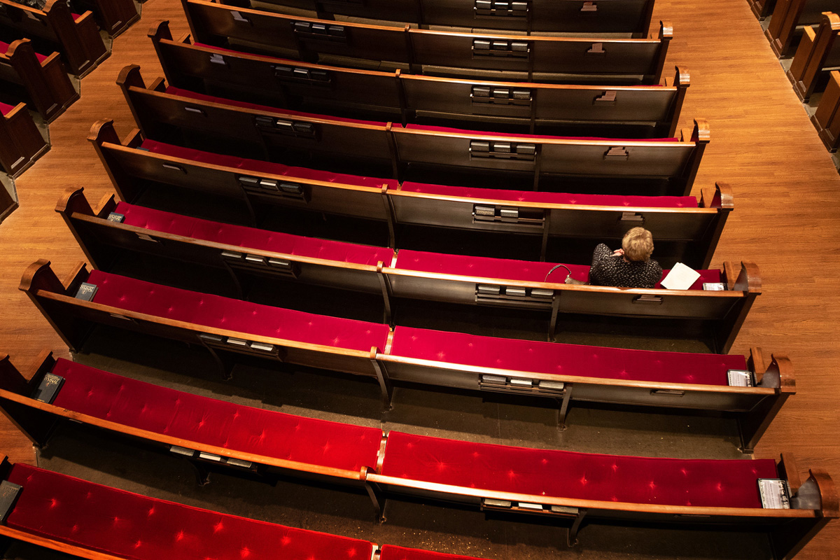 Susan Logan worships in an empty pew section at Belmont United Methodist Church in Nashville, Tenn., Sunday, March 15, 2020, after church leadership encouraged people to worship from home via video livestream in response to the coronavirus. In keeping with the Metropolitan Nashville mayor’s “Safer at Home” directive, the church building has since been closed. Photo by Mike DuBose, UM News.