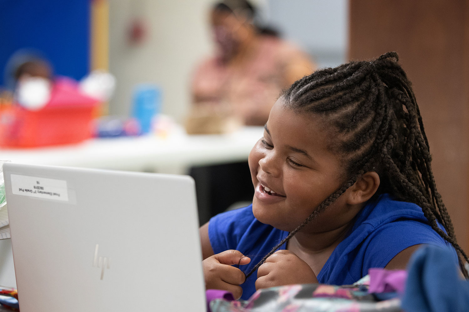 A first grade student interacts with her teacher and classmates by computer during the first day of the Sanctuaries of Learning program at Jones Memorial United Methodist Church at Crestmont Park in Houston. The program, started by the Texas Conference of The United Methodist Church, offers a safe space, internet access and other resources in area churches, allowing parents to return to work and their children to continue their education during the COVID-19 pandemic. Photo by Mike DuBose, UM News.