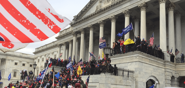 A crowd pressing up the steps towards the Senate Chamber of the Capitol. Photo by Tyler Merbler at Flickr. 2021.