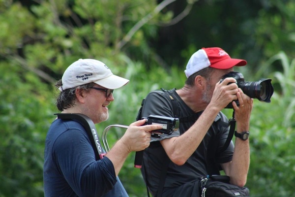 Joey Butler (L) and Mike DuBose (R) working together to capture imagery during pre-pandemic days. (Photo by E Julu Swen, UM News.)