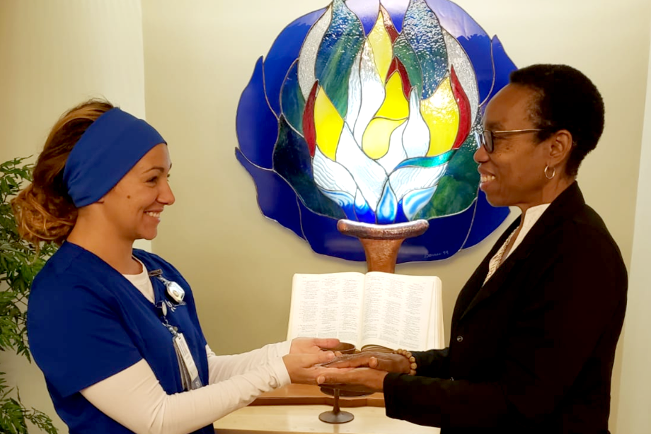 The Rev. Denise Sawyer, right, prays with a staff member at Florida's Cape Coral Hospital. Image courtesy of the Great Plains Annual Conference. 