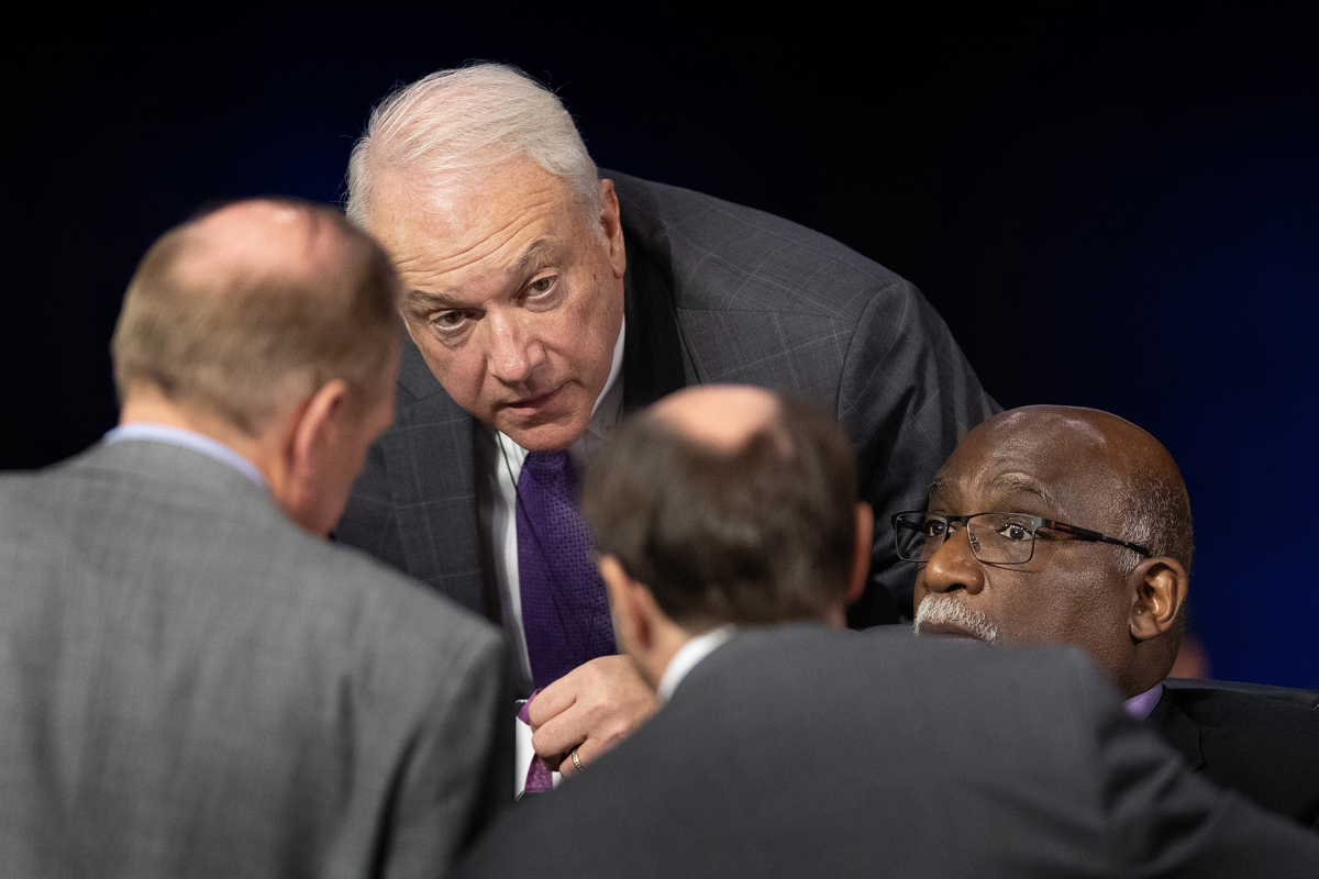 Bishops Thomas J. Bickerton (center) and Gregory V. Palmer (right) confer with colleagues on legislative procedures during the 2019 United Methodist General Conference in St. Louis. Bickerton is the Council of Bishops representative on the Commission on the General Conference. The commission — meeting behind closed doors — reviewed an investigation that found evidence of four ineligible people casting votes using the credentials of delegates who were not present. File photo by Mike DuBose, UM News.