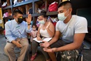 The Rev. Joel Hortiales (left) prays with Carlos Ivan Baran Hidalgo; his wife, Danelly Mazariegos Morales; and their 3-year-old daughter, Scarlett Juliette, at the Camino de Salvación shelter in Tijuana, Mexico. The family fled violence in Guatemala and is hoping to pursue a claim for asylum in the U.S. Hortiales is a United Methodist missionary and serves as director of Hispanic/Latino ministries and border concerns for the California-Pacific Conference. Photo by Mike DuBose, UM News.