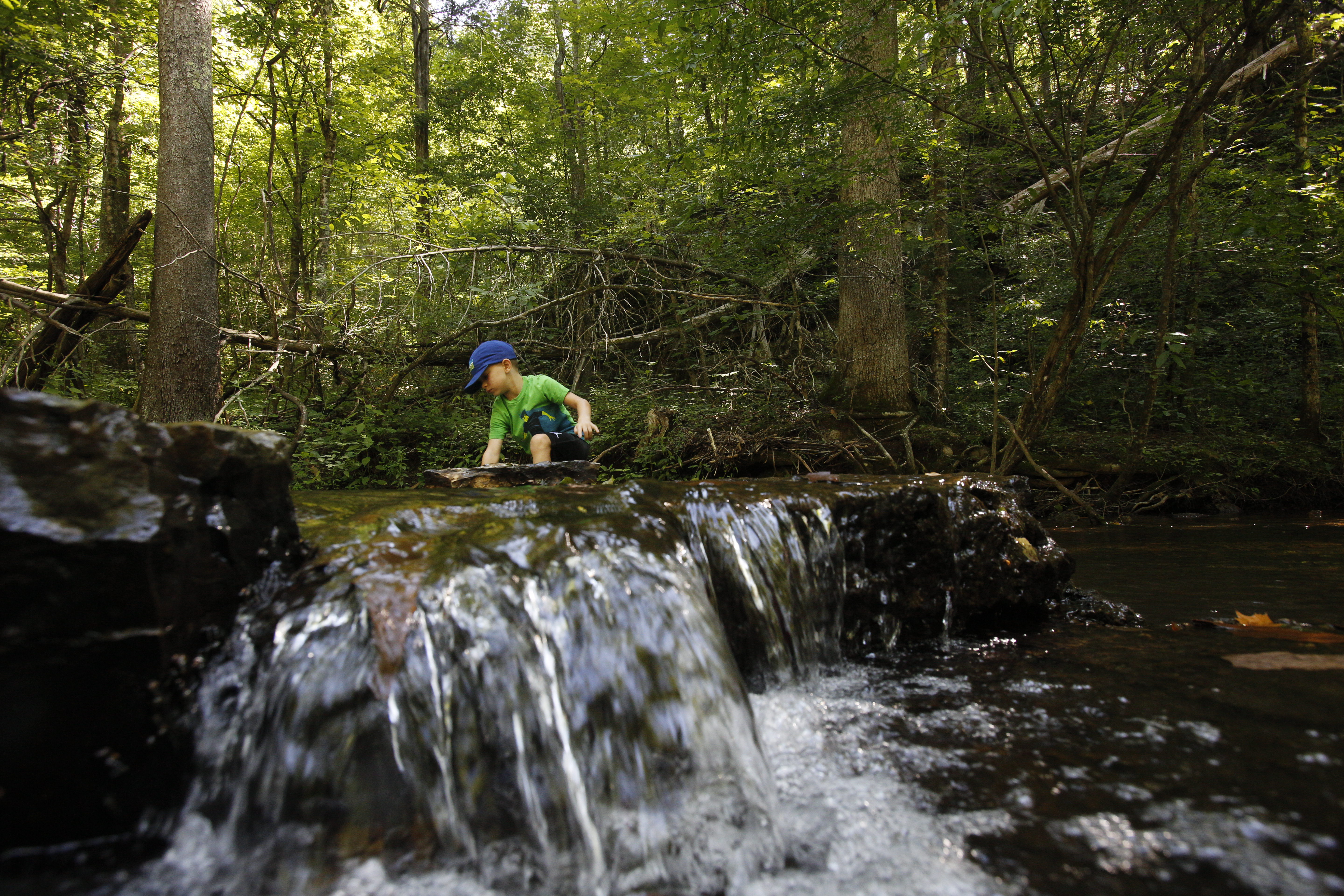 Reid Lemmon explores the creek at Cedar Crest Camp in Lyles, Tennessee. Cedar Crest has been owned and operated by the Tennessee Annual Conference of the United Methodist Church since 1959. Photo by Kathleen Barry, United Methodist Communications.