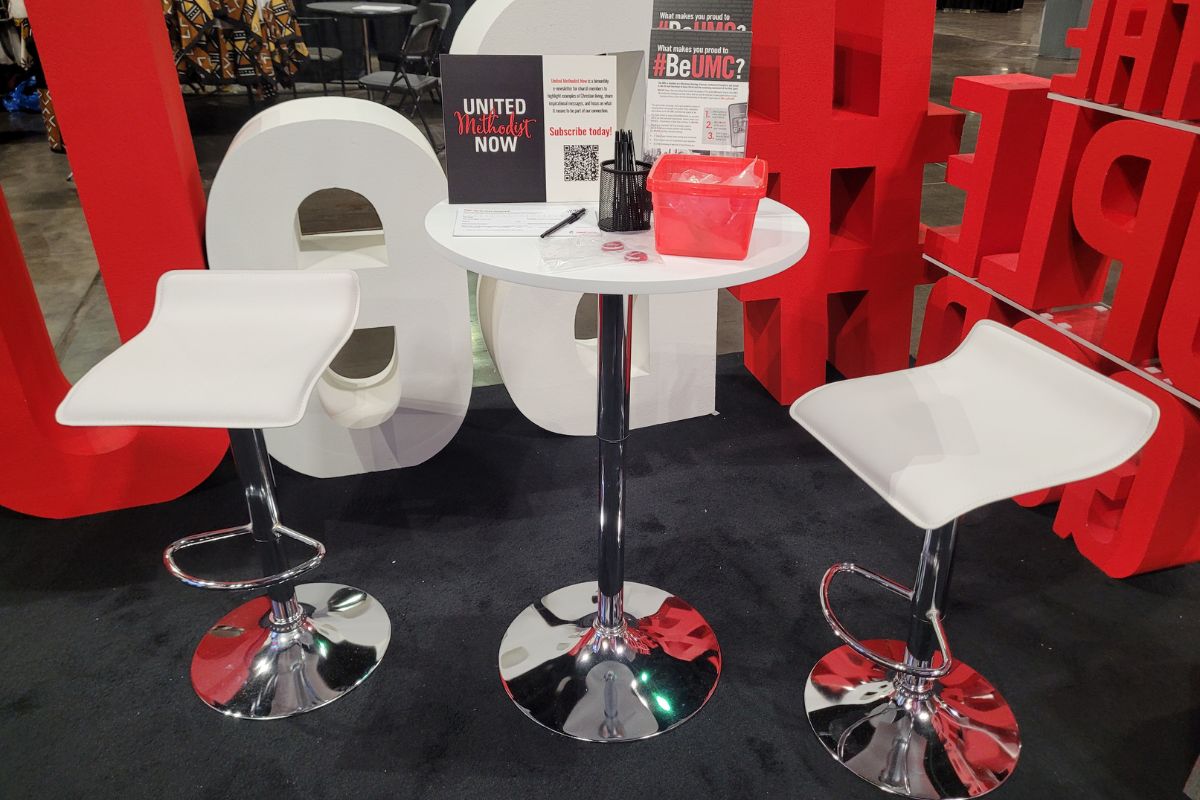 Perched upon the tables within the booth, visitors could get literature about the #BeUMC campaign, sign up for UM Now and take home a branded cell phone ring. (Photo by Brenda Smotherman.)