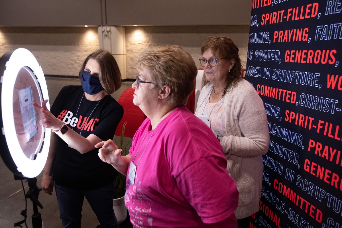 The selfie booths were a hit with Assembly attendees. Brenda Smotherman is shown assisting booth visitors in emailing their photos. (Photo by Mike DuBose.)