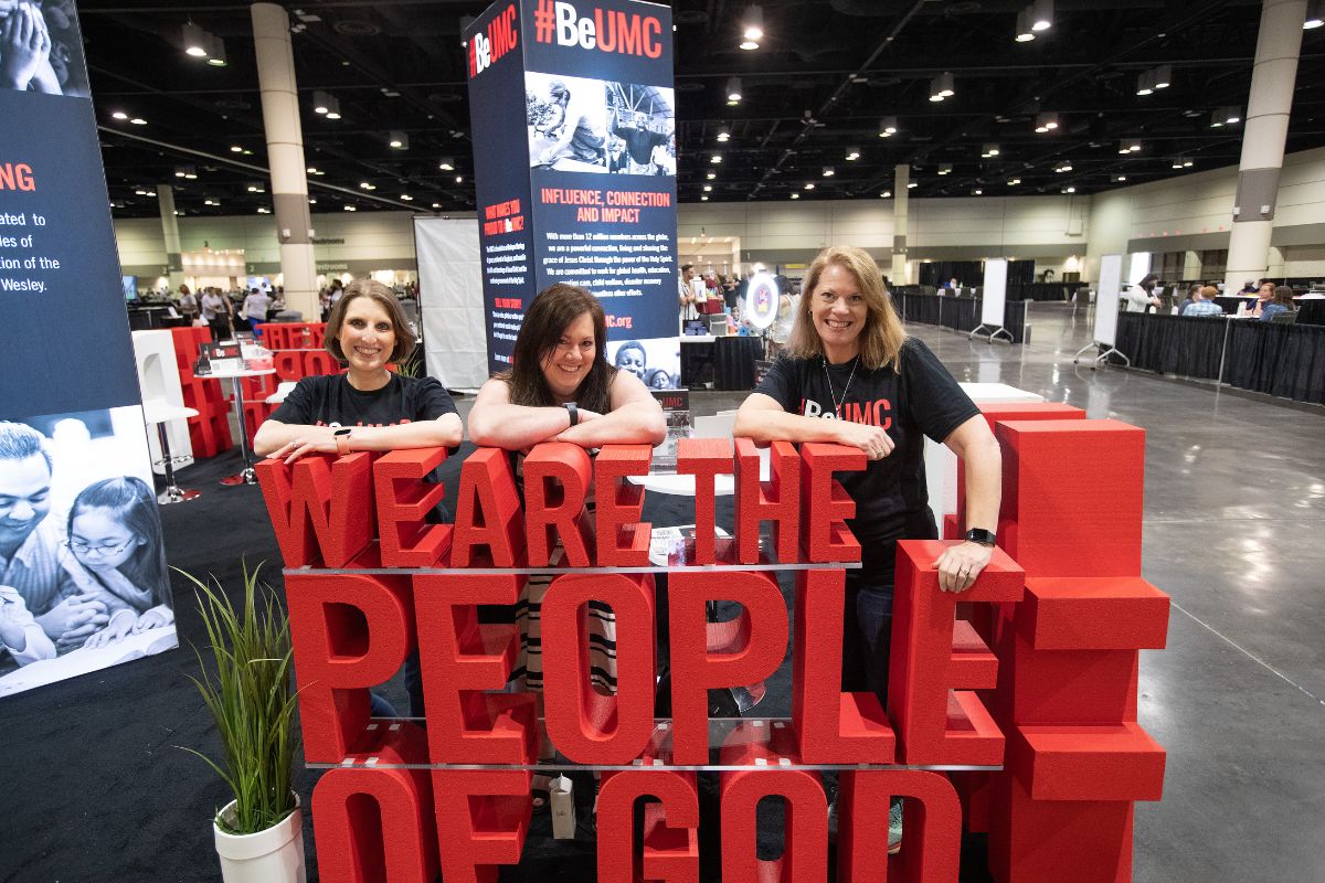 Brenda Smotherman and Crystal Caviness were the main #BeUMC booth workers, and Jennifer Rodia pitched in to help when the need arose. [Patty DelliBovi who had done the prep work but whose health kept her from traveling was there in spirit.] The trio took a moment to celebrate being people of God with the large letters that were well received by all. Pictured L-R: Brenda, Jennifer, Crystal. (Photo by Mike DuBose.)
