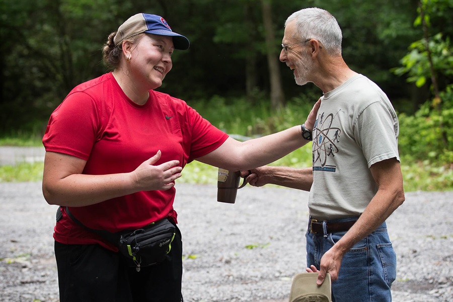 The Rev. Alan Ashworth (right) shares a laugh with Appalachian Trail thru-hiker "Flame" at a free hiker feed sponsored by New Hope Union United Methodist Church near Bastian, Va. Photo by Mike DuBose, UMNS.