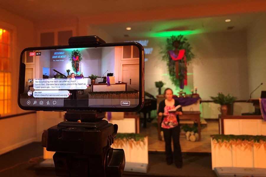 An iPhone streams the online worship service on Facebook Live at Glendale United Methodist Church in Nashville, Tenn. Due to the 2020 coronavirus pandemic, many churches are turning to online streaming to share worship. On the altar is the Rev. Stephanie Dodge, lead pastor. Photo by Steven Adair, United Methodist Communications.