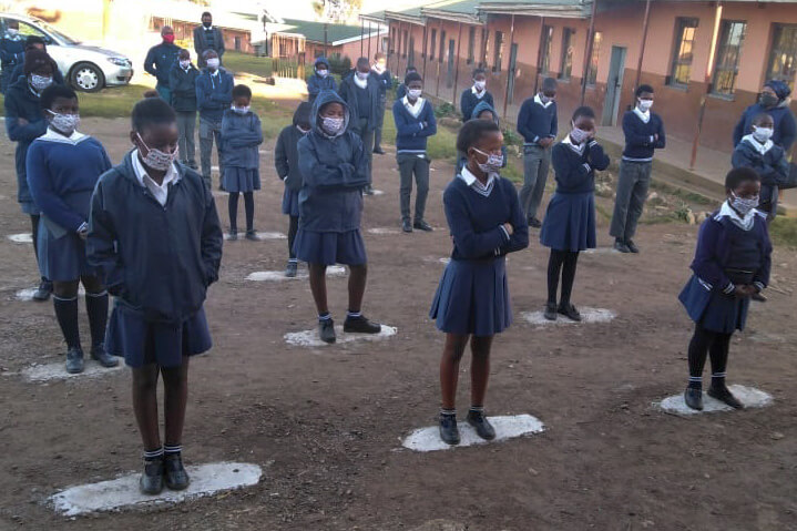 Students wear face masks and observe social distancing as they receive their daily orientation prior to starting classes at Port Edward Primary School in Durban, South Africa. Photo by Nandipha Mkwalo, UM News.