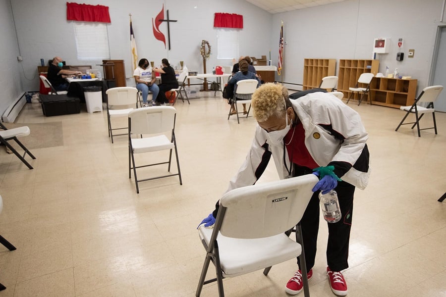 Church volunteer Tena Armstrong cleans chairs in the waiting area for a COVID-19 vaccination clinic at St. Mark’s United Methodist Church in Charlotte, N.C. Photo by Mike DuBose, UM News.