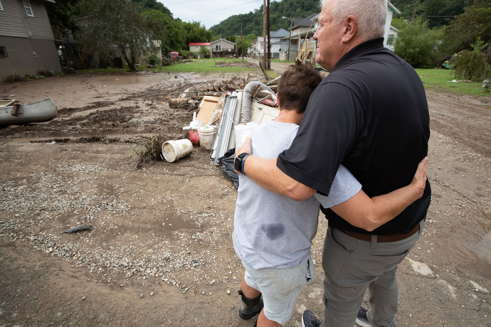 The Rev. Roy Harlow prays with flood survivor Jennifer Taylor outside of her home in Wayland, Ky., Harlow is pastor of Graceway United Methodist Church in nearby Langley. Photo by Mike DuBose, UM News.