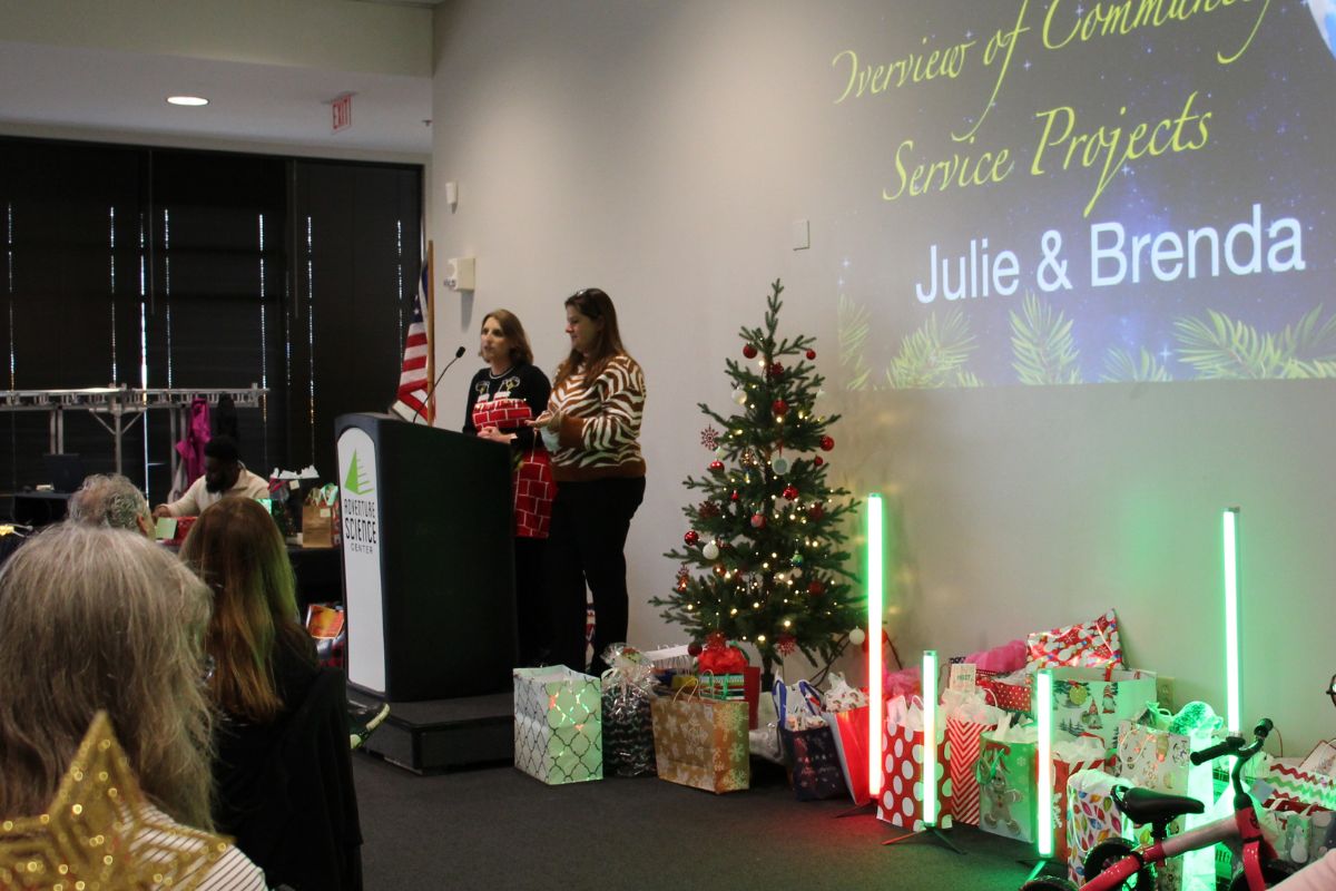 Brenda Smotherman (Right) and Julie Dwyer (Left) thank the United Methodist Communications staff for their generosity during the Christmas party. (Photo by Michelle Maldonado, United Methodist Communications.)