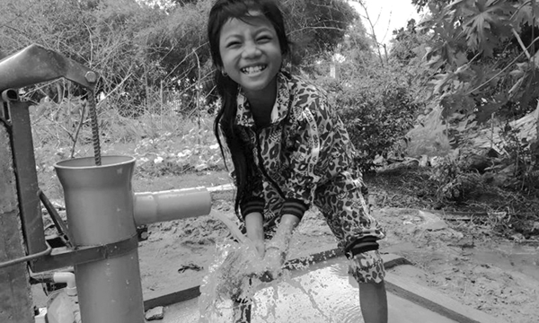 UMCOR Sunday - Little Girl gathering water at a pump.