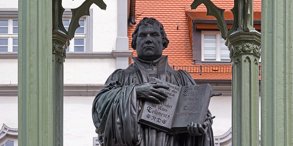 Monument of Martin Luther in Wittenberg, Germany. It was the first public monument of the great reformer, designed 1821 by Johann Gottfried Schadow. Martin Luther (1483-1546) was a German monk, theologian, and church reformer and the translator of the bible into German. Photo Credit: typo-graphics/GettyImages