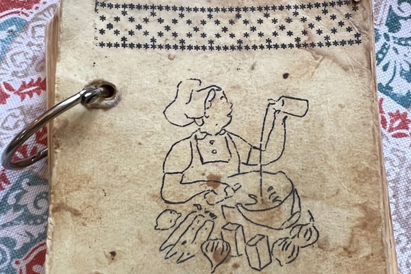 The spiral clips and artwork by hand on this vintage cookbook represents a labor intensive effort by the church in presenting their recipes. (Photo courtesy of Lilla Marigza, United Methodist Communications.)