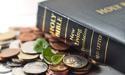 Photo of a Bible and a pile of coins. Courtesy Photo: Lewis Center.