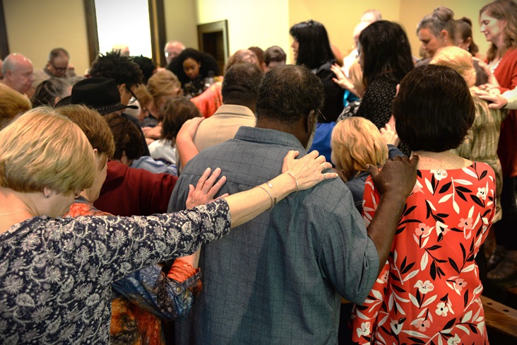 Diverse group praying Wells UMC diverse-group-praying