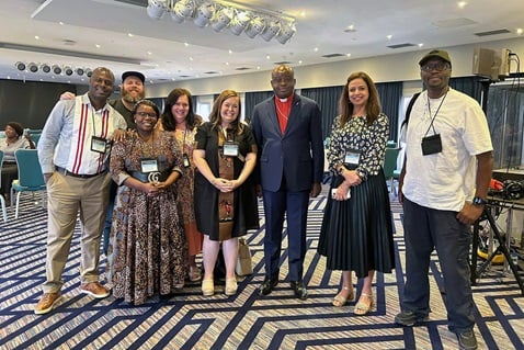 From left, Pacome Nguessan, Matt Crum, Priscilla Muzerengwa, Jennifer Rodia, Ashley Gish, North Katanga Area Bishop Mande Muyombo, Poonam Patodia and Chilima Karima celebrate together at the end of training on regionalization. All but the bishop work for United Methodist Communications. Photo courtesy of United Methodist Communications.