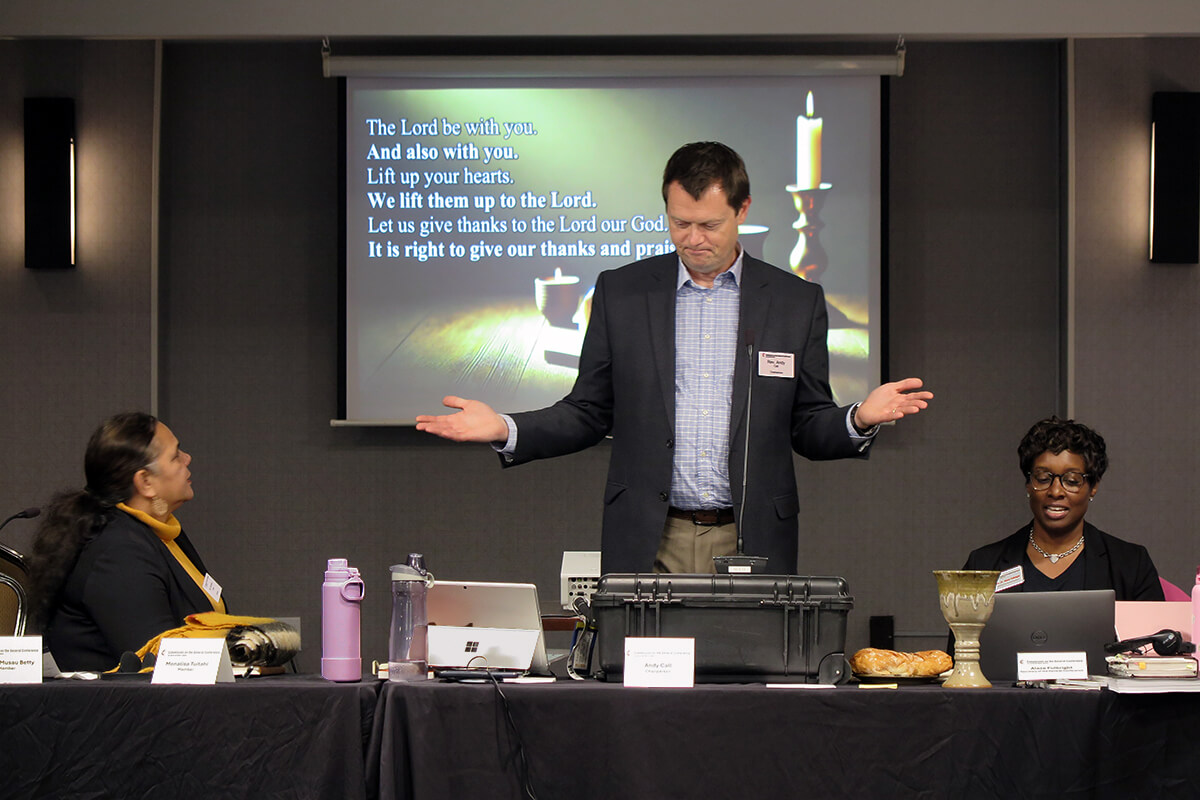 The Rev. Andy Call, chair of the General Conference commission, helps lead Holy Communion during opening worship Nov. 19 at the General Conference commission’s meeting in Charlotte, N.C. Sitting beside Call are Monalisa Tui'tahi (left), the commission’s vice chair, and the Rev. Aleze M. Fulbright (right), the new General Conference secretary. During the meeting, the commission began preparations for the next gathering of The United Methodist Church’s top lawmaking assembly, scheduled in 2028. Photo by Heather Hahn, UM News.