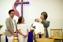 The Rev. Anne Lau Choy baptizes an infant at St. Paul United Methodist Church in Fremont, Calif. where she serves as pastor. Photo by Brian Teodoro.